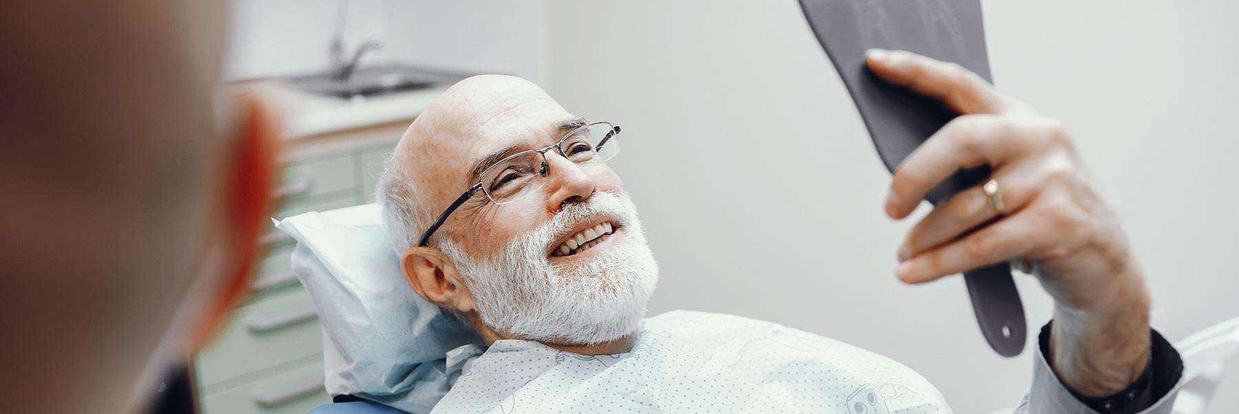 a middled aged man getting top-quality dental bridges in Clayton, NC