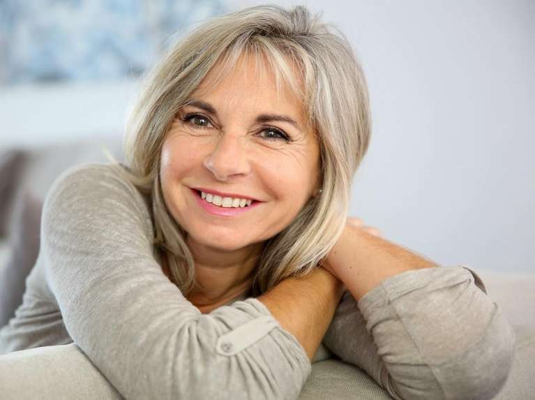 a lady with top-quality dental bridges in Clayton, NC