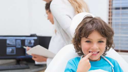A kids smiling after a getting dental sealant in Clayton, NC