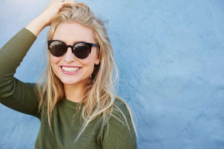 A woman smiling after getting Dental Bridges in Clayton, NC
