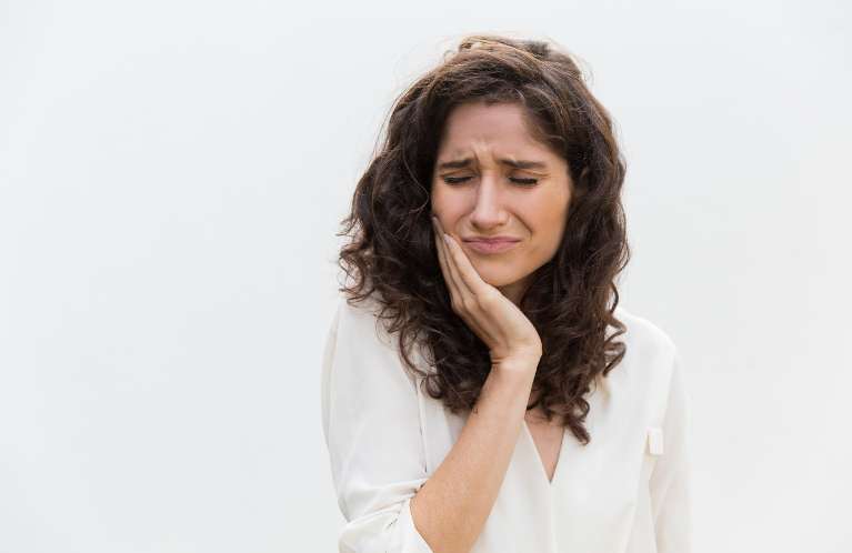 A woman with emergency dental emergency in Clayton, NC.