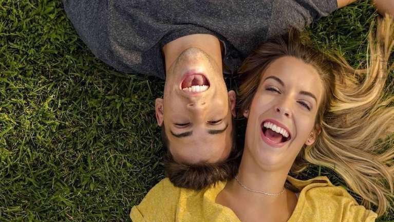 A couple lying on the ground with Tooth-Colored Fillings in West Clayton