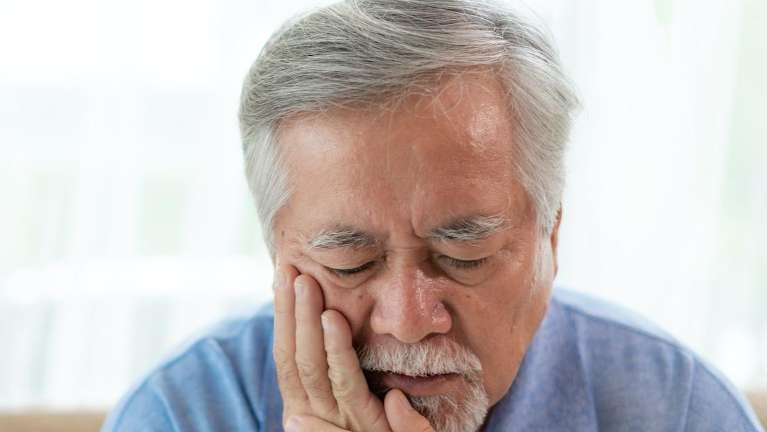 An asian elderly man with Toothache in West Clayton, NC