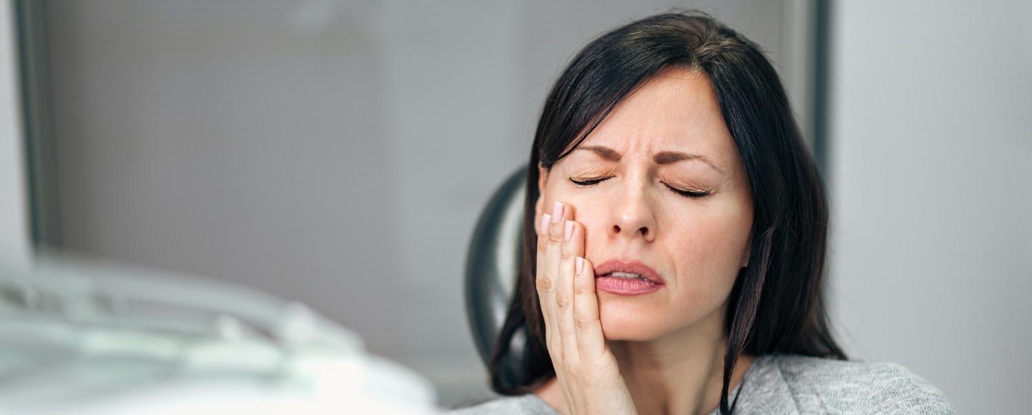 woman with dental pain at dentist in clayton nc